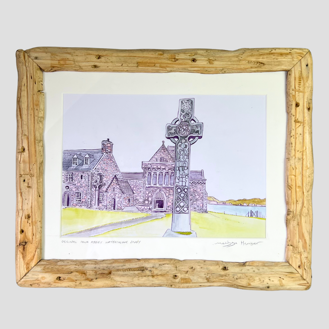A framed watercolour painting depicting Iona abbey and a Celtic cross by local artist Melissa Humber